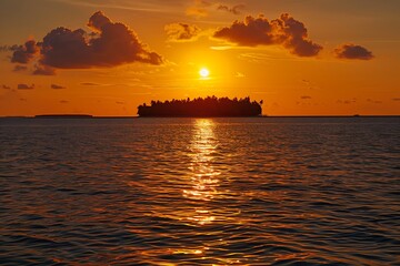 sun shines on the sea, casting an orange glow over everything below it. In front of you is Maldives's famous island