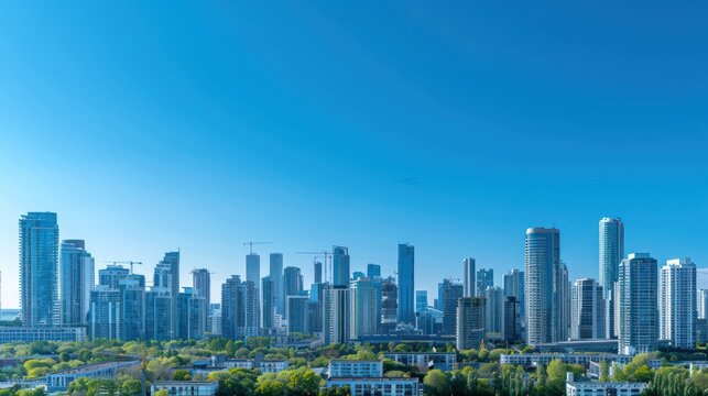 An expansive view of an urban skyline with numerous high-rise buildings beneath a clear blue sky