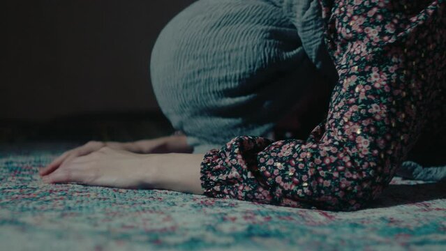Woman wearing Hijab doing a Prayer at home