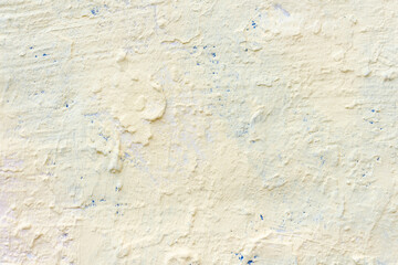 Absctract light yellow coloured wall background. Close-up view of stained painted textured concrete wall. Copy space for your text or decorations. Colorful construction material background theme.