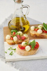 Round mozzarella, cherry tomatoes and microgreens on a piece of white bread