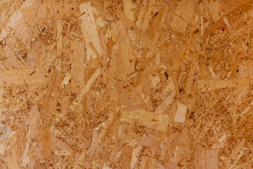 Abstract brown wooden particle board (particleboard, chipboard, or low-density fiberboard)...