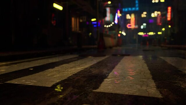 the vibrant neon lights and rainy ambiance of a bustling Asian city street at night.