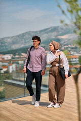 After a day at the office, a business man engages in conversation with his Muslim colleague wearing a hijab