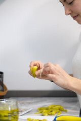 woman making moorish skewers with chillies in the kitchen at home