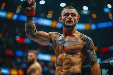 Tattooed mixed martial arts fighter raising his arm in victory, crowd in the background