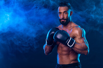 Boxer on the blue neon background. Download high resolution photo for advertising online sports betting. Picture for ads a bookmaker application.