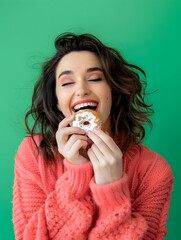 Close-up portrait of a satisfied pretty girl eating doughnuts