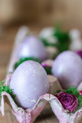 Easter colored eggs in a basket with moss