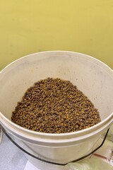 A lot of bee perga as called ambrosia, bee pollen in a plastic container. Top view. Healthy eating. The energy of life. Close-up