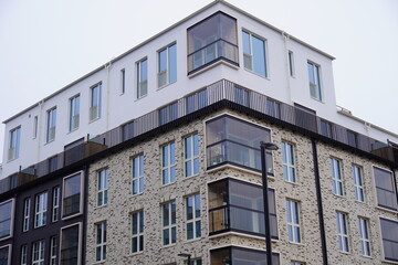 Close up of new modern beige and brown building during the day with no people. Many windows. Tallinn, Estonia, Europe 2024.