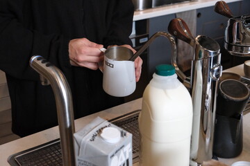 Barista steaming milk 