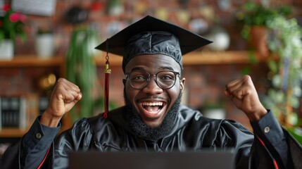 Fototapeta premium Man in Cap and Gown Using Laptop