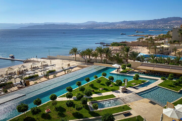 Scenic view of swimming pool and beach at Gulf of Aqaba in Aqaba, Jordan