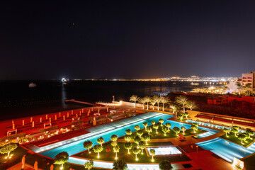 Scenic view of illuminated swimming pool and beach at Gulf of Aqaba in Aqaba, Jordan