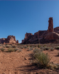 Low angle view of Courthouse Towers on a Spring day with blue skies in Arches National Park 