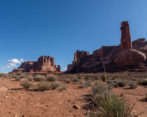 Low angle view of Courthouse Towers on a Spring day with blue skies in Arches National Park 