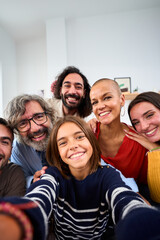 Vertical. Joyful Caucasian family smiling hugging taking a selfie photo indoor. Three generations Caucasian people looking at front camera at home. Happy people relations in domestic life