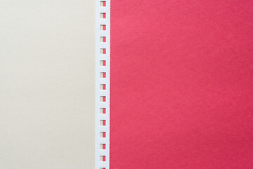 white and red construction paper and white paper spiral notebook binding strip