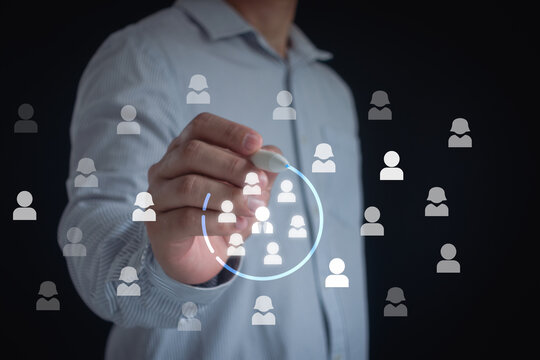 Marketing target audience concept. Marketing segmentation, customer care, customer relationship management (CRM) and team building concepts. Businessman writing circle to mark to focus customer group.