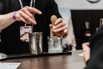 The bartender prepares cocktails for the client.