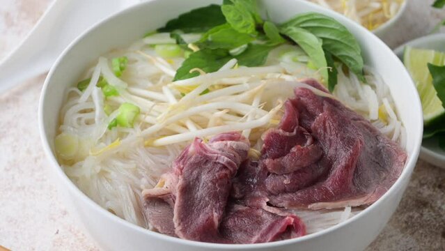 pho bo, vietnamese raw beef and rice noodle shoup