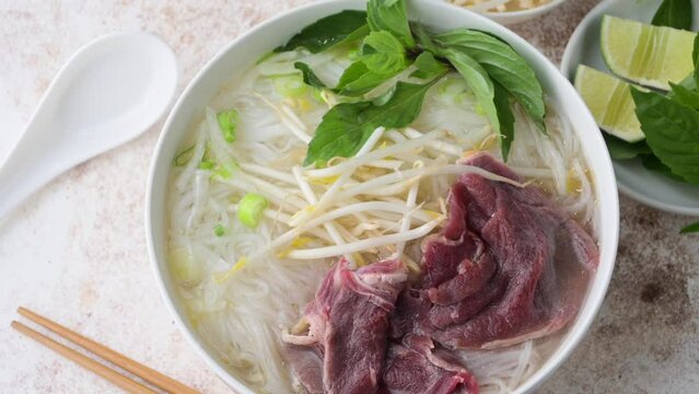 pho bo, vietnamese raw beef and rice noodle shoup