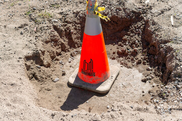 Obraz premium dirt hole and City of Toronto branded traffic cone