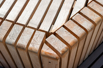 close-up of wooden structure composed of various lengths of hardwood slats, some with curved edges