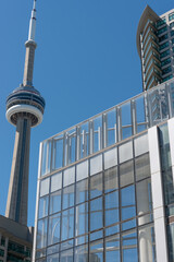 Obraz premium CN Tower and triangular glass box at 10 York Street, location of a condominium complex, in downtown Toronto, Canada