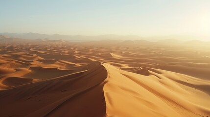 Warm sunset casting shadows over undulating desert sand dunes