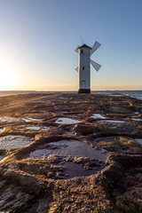 lighthouse mill on the seashore in Swinoujscie in Poland in spring
