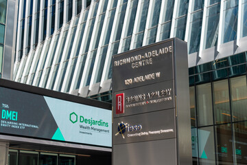 Obraz premium sidewalk branding sign outside Richmond-Adelaide Centre (with company logos for Robins Appleby law firm and IESO) in Toronto, Canada
