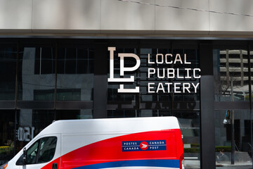 Obraz premium exterior of LOCAL Public Eatery, a restaurant, located at 141 Adelaide Street West (with Canada Post delivery truck) in Toronto, Canada