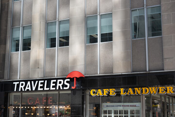 Obraz premium exterior building and signs of Travelers Cafe and Cafe Landwer, a restaurant, located at 165 University Avenue and Adelaide in Toronto, ON