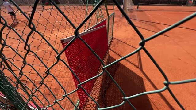 tennis court dragnet hanging on fence