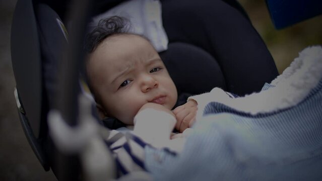Young Baby Boy Lying in pram buggy Waking up after Sleeping