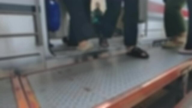 Cinematic shot. Passengers stepping out through the commuter train&rsquo;s automatic door. Modern public transport concept. Out of focus