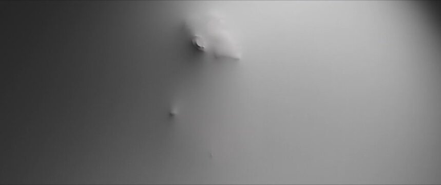The shape of a dancing and screaming woman reveals itself from the white wall