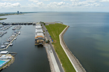 aerial shot of a gorgeous spring landscape at Breakwater Park with ocean water, lush green trees...
