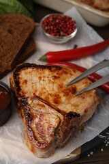 Tasty marinated meat, chili and bread on table, closeup