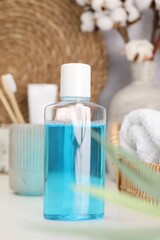 Bottle of mouthwash on white table in bathroom