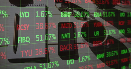 Image of financial data processing over desk with notebook and smartphone