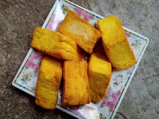 Tahu kediri. Yellow tofu or what is known as tofu kediri which has been fried and placed in a container. Yellow tofu is a typical food from the city of Kediri, Indonesia.