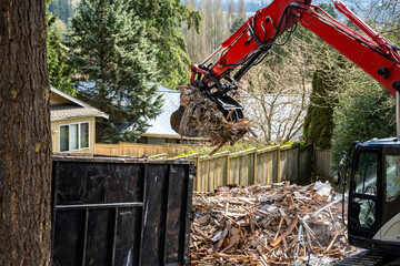 Demolition cleanup and debris removal, heavy equipment with jawbone bucket used to pickup debris...