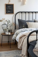 A black metal frame bed with an elegant design, set against the backdrop of a white wall in a Scandinavian style interior