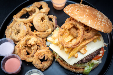 Cheese hamburgers sandwich with fried potatoes with black background, nice