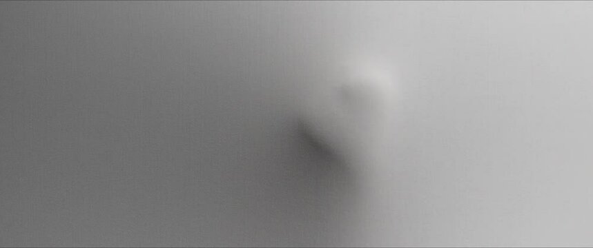 A skinny woman's body appears from the white surface