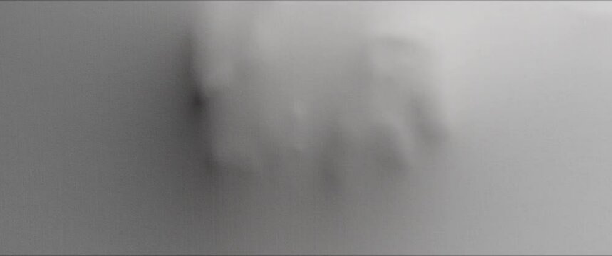 A skinny woman's back appears from the white surface