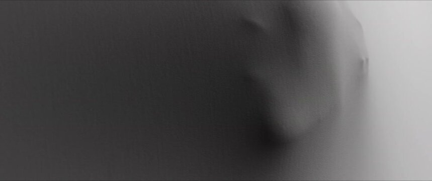 A creepy woman's face extrudes from the wall surface